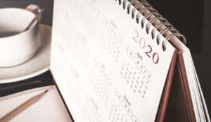 Desktop calendar sitting on desk showing year of 2020
