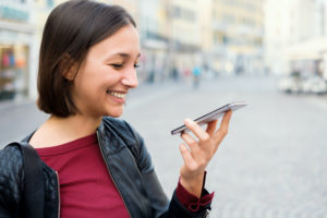 woman outside asking siri a question